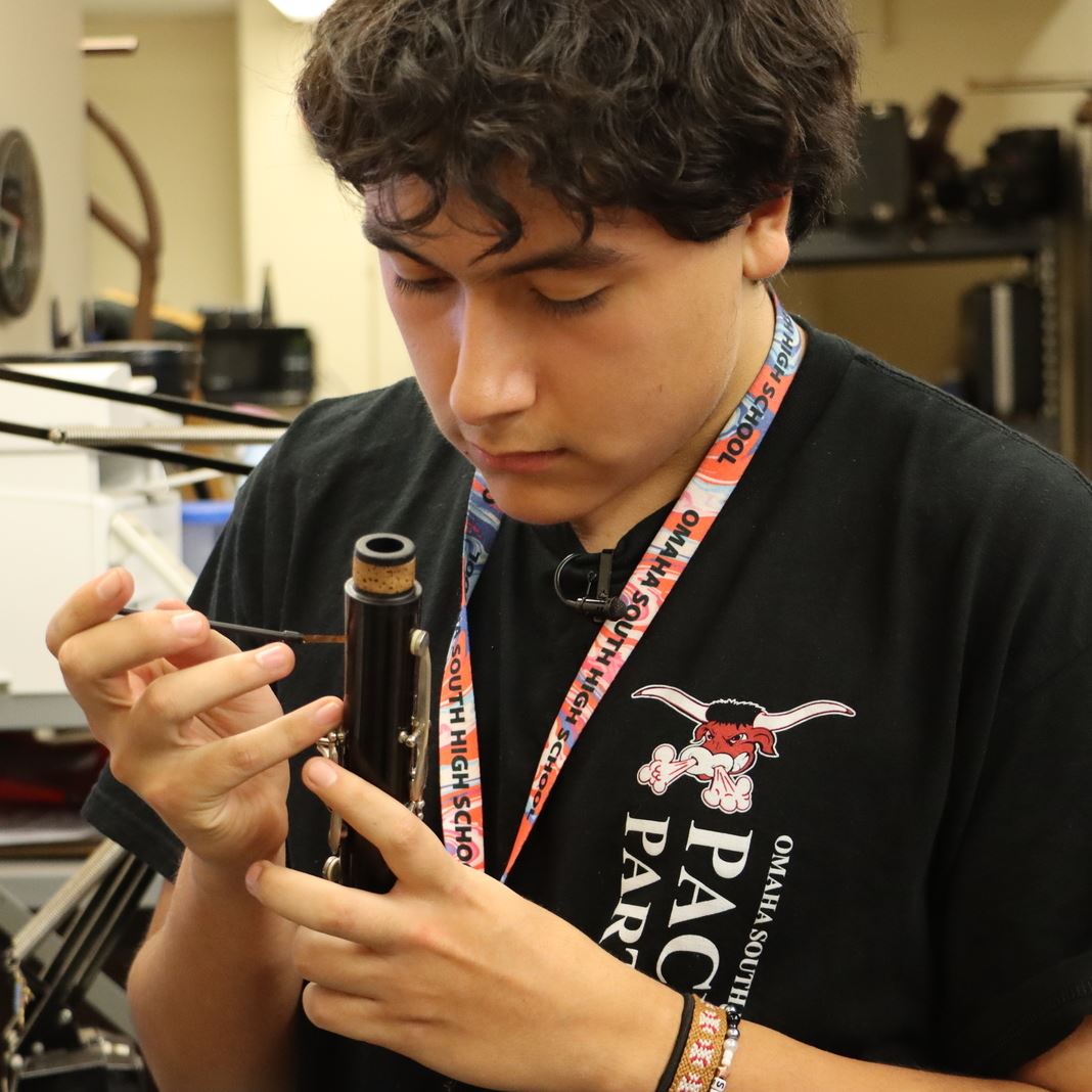  Cesar Gomez works on repairing a clarinet